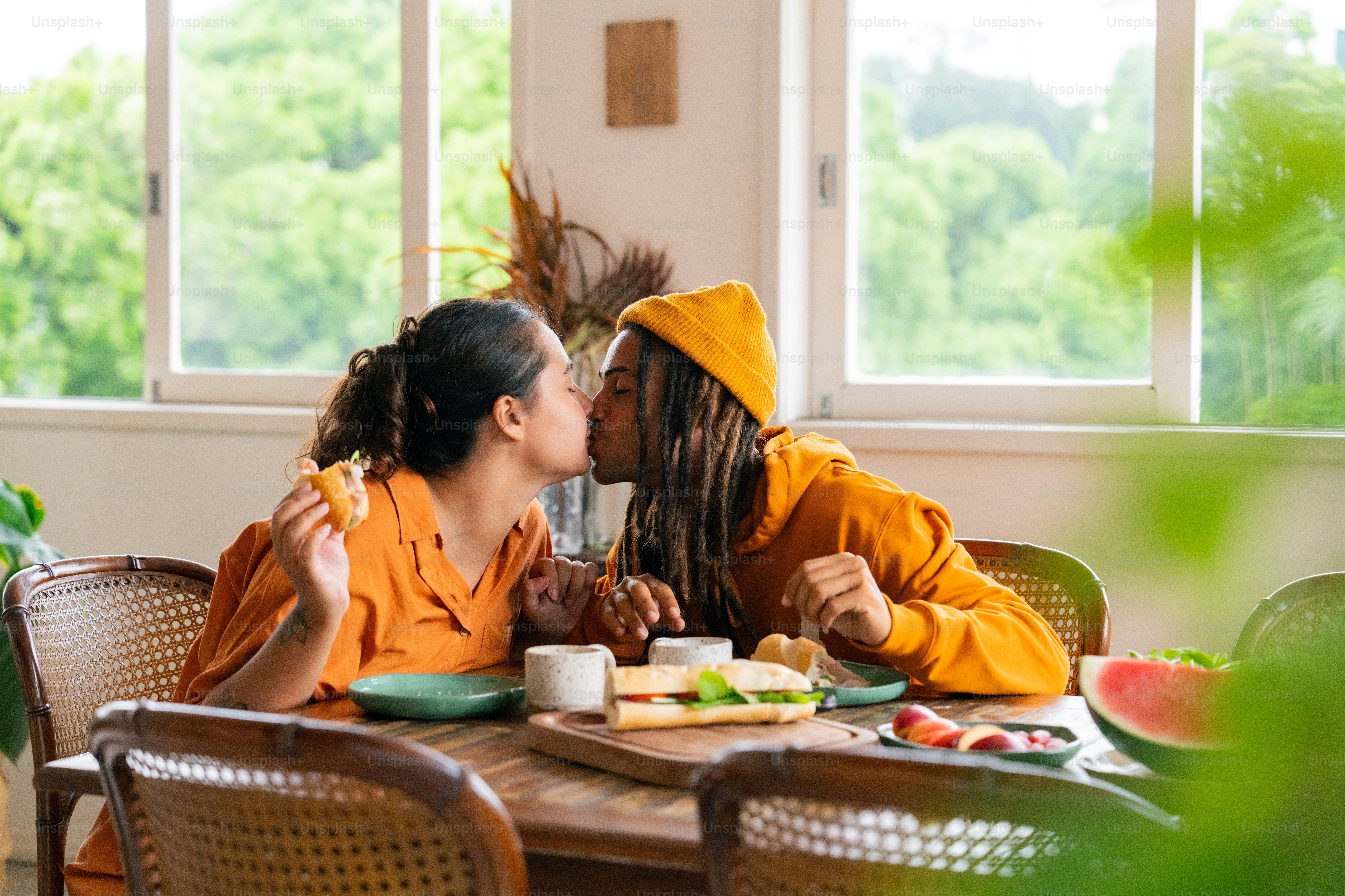 a couple of women sitting at a table with plates of food
