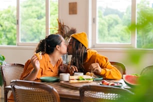 a couple of women sitting at a table with plates of food