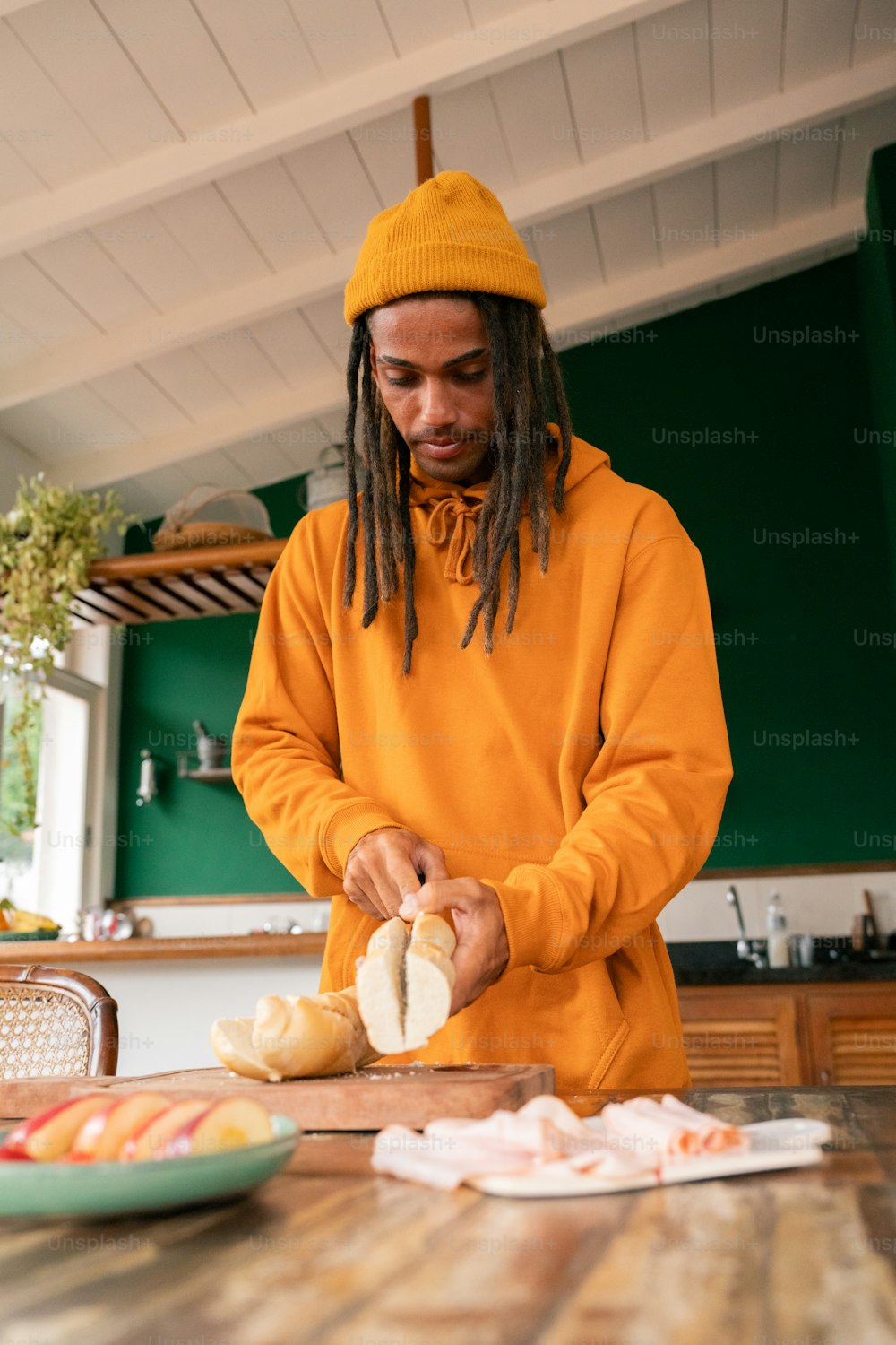 a man with dreadlocks is preparing food on a table