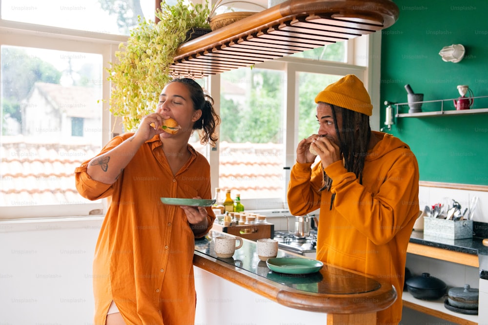 a couple of people that are standing in a kitchen