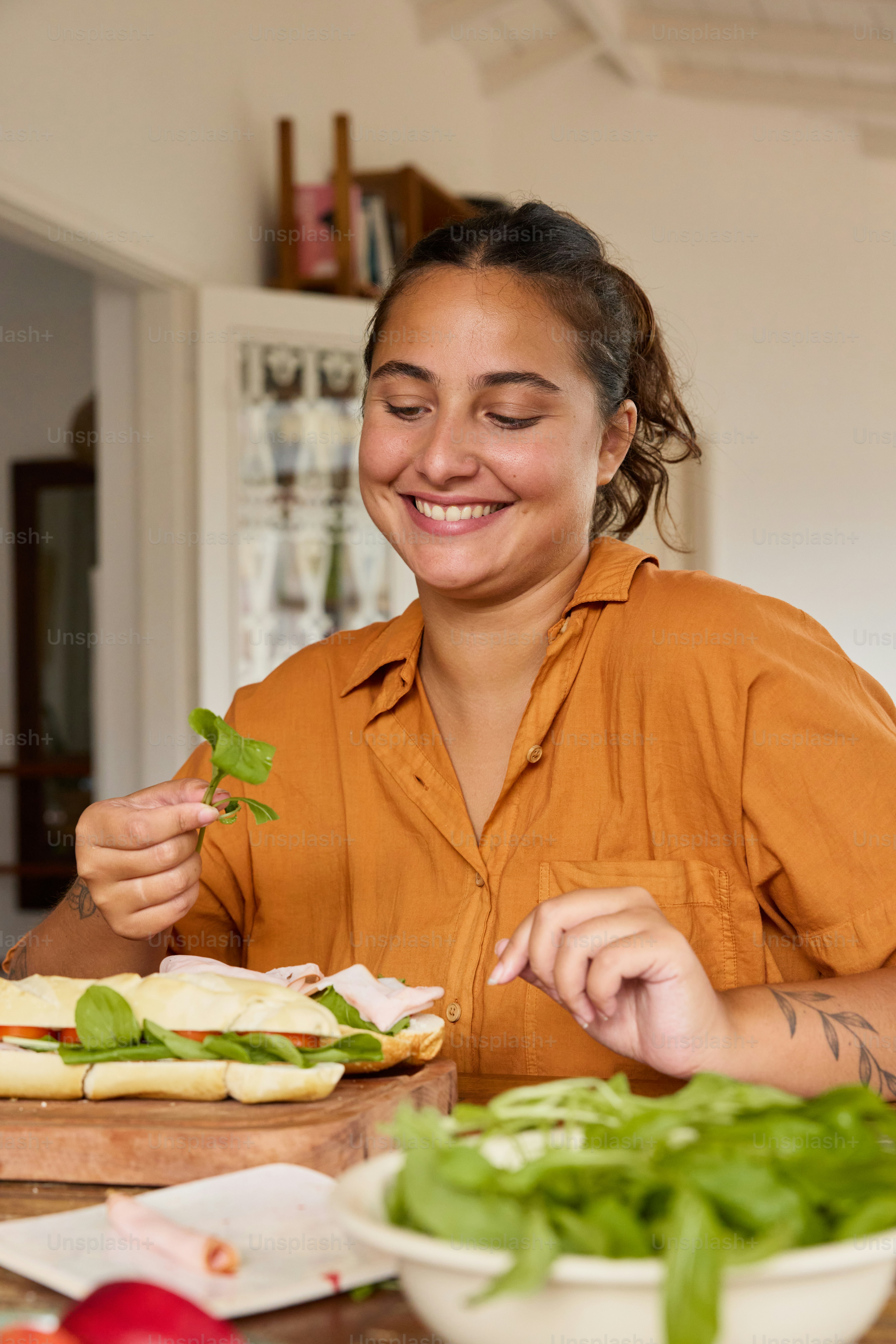 a woman sitting at a table with a plate of food