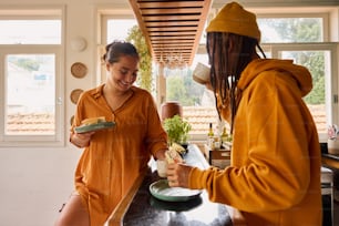 two women in orange robes are preparing food