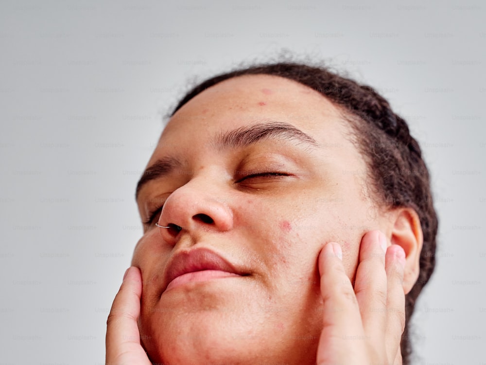 a woman with her hands on her face