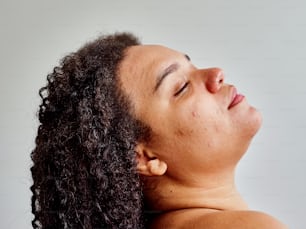 a close up of a person with curly hair