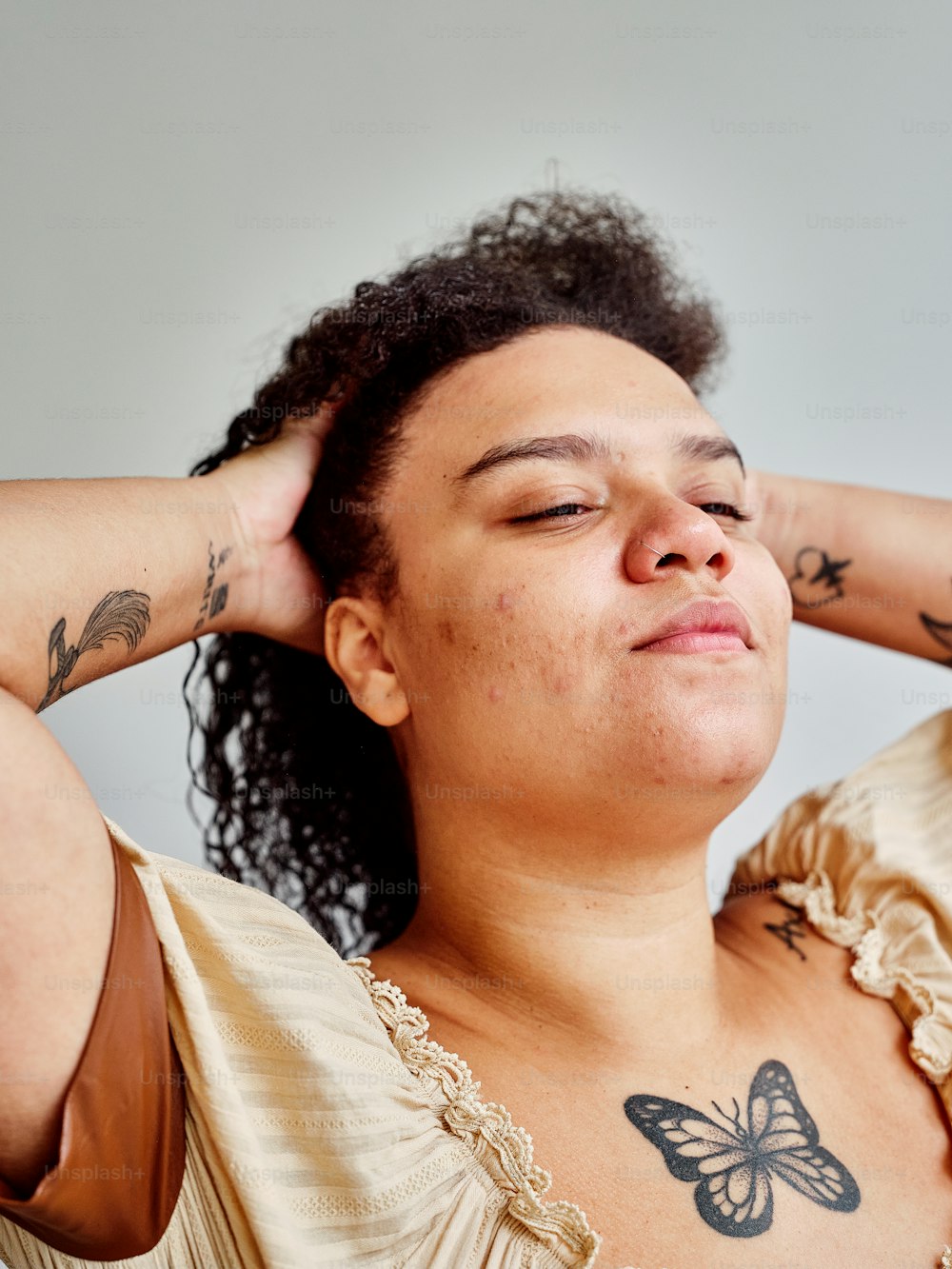 a woman with a butterfly tattoo on her chest