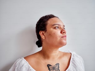 a woman with a butterfly tattoo on her chest