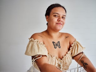 a woman with a butterfly tattoo sitting in a basket