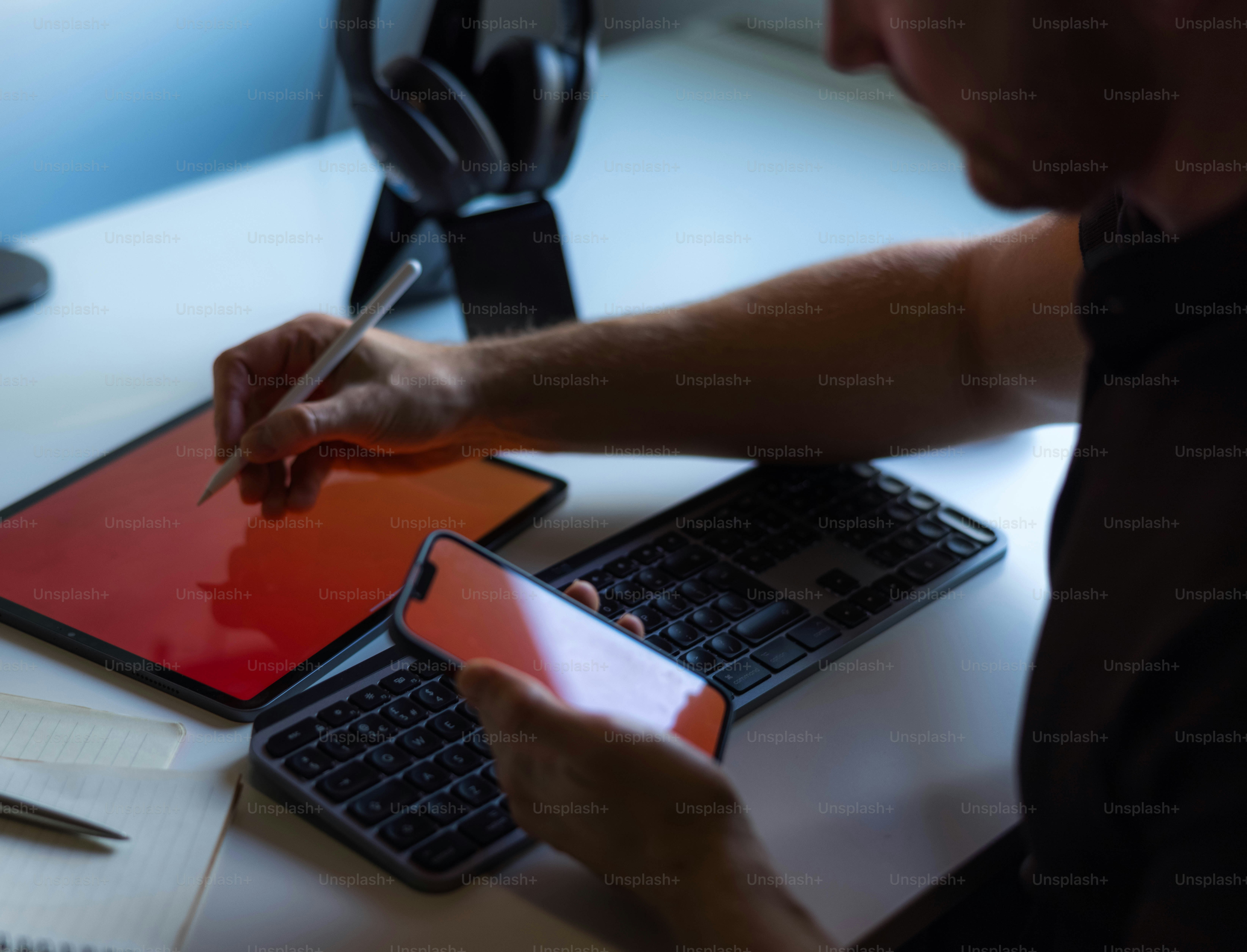 A man sitting at a desk writing on a piece of paper photo – Technology ...
