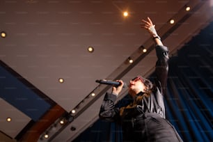 a man holding a microphone up in the air