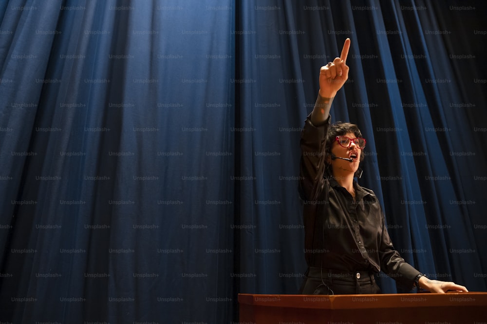 a woman giving a speech at a podium