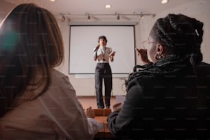 a woman giving a presentation to a group of people