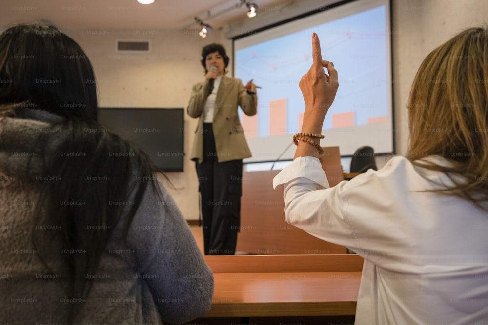 a woman giving a presentation to a group of people