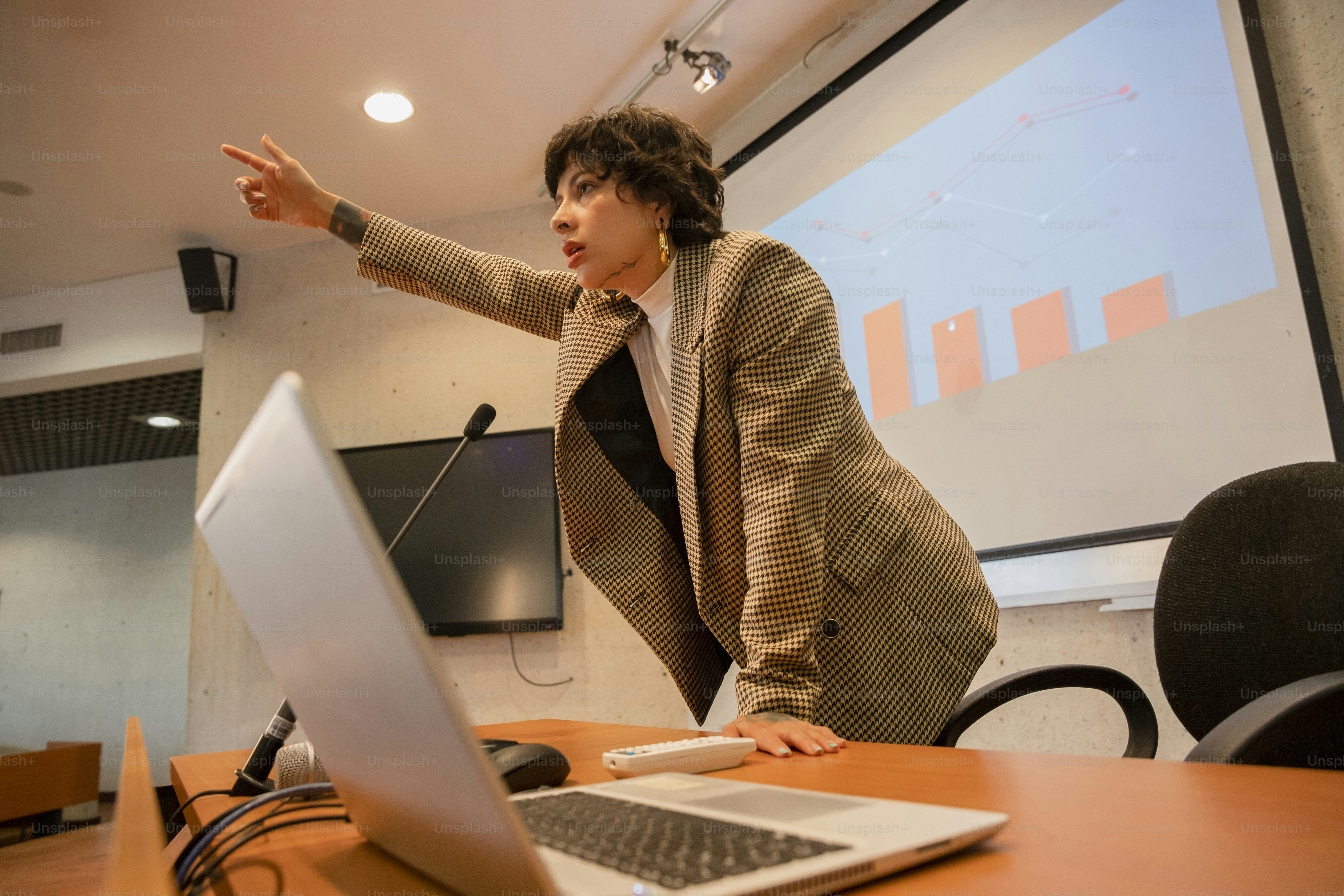 A woman standing in front of a laptop computer photo – Spokesperson ...