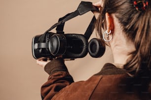 a woman holding a camera up to her face