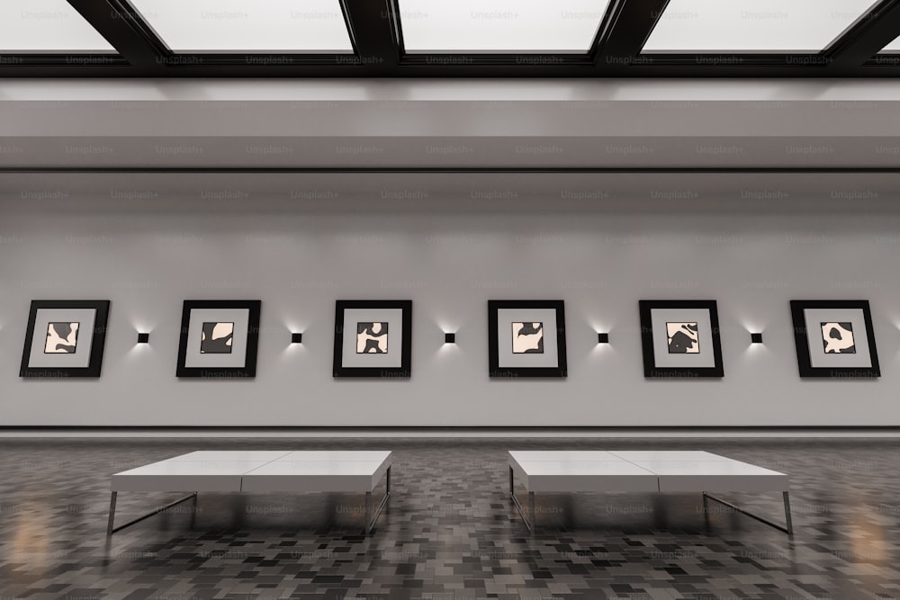an empty room with benches and pictures on the wall
