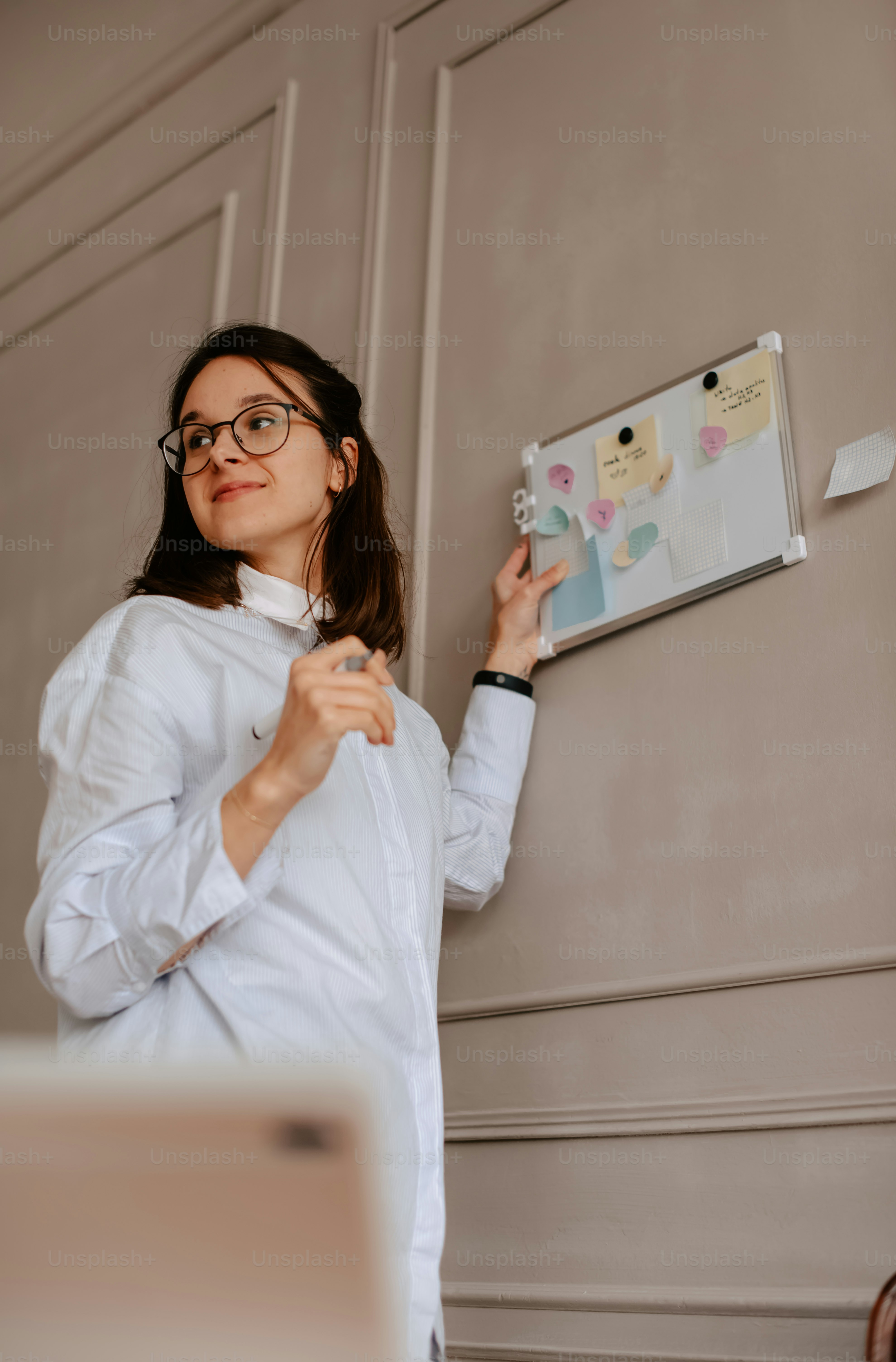 a woman in a white shirt holding a clipboard