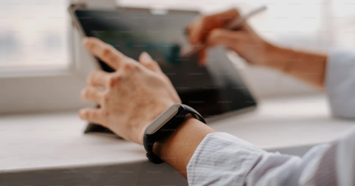User Using Tablet A person using a tablet on a table photo – Technology Image on Unsplash