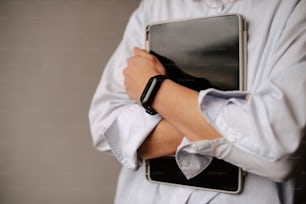 a man is holding a tablet computer in his hands