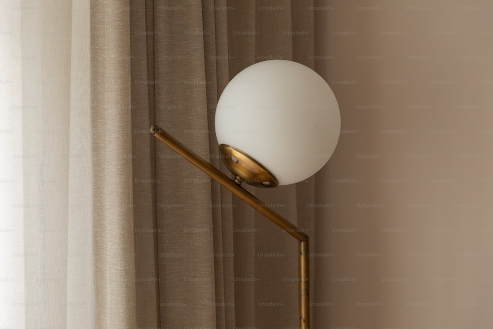 a lamp that is next to a curtain