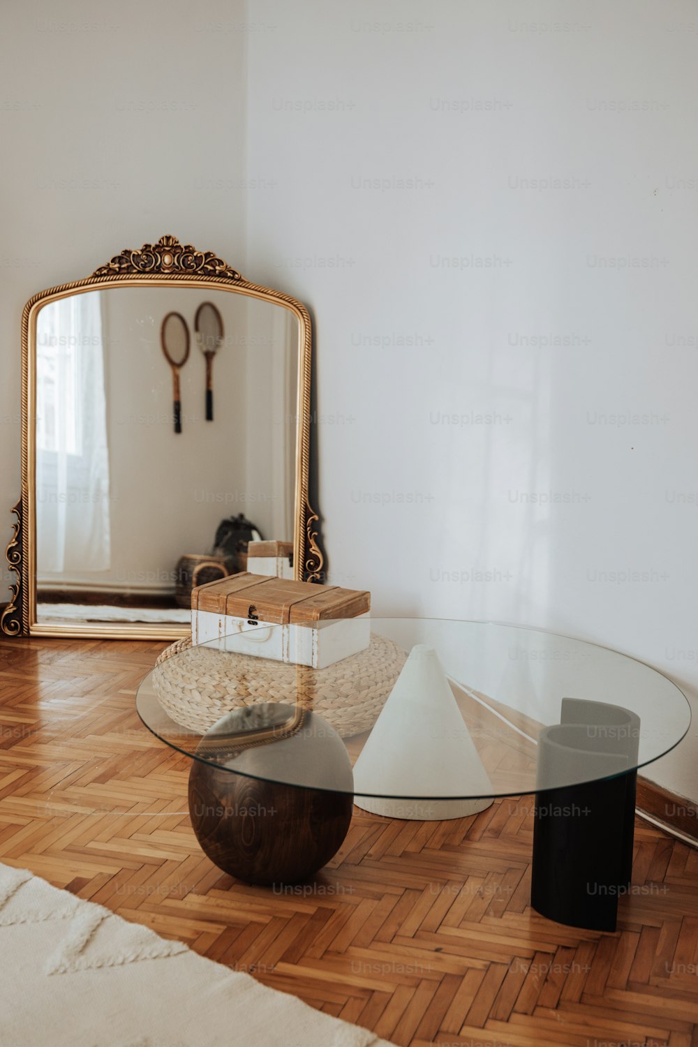 a living room with a table, mirror and other items