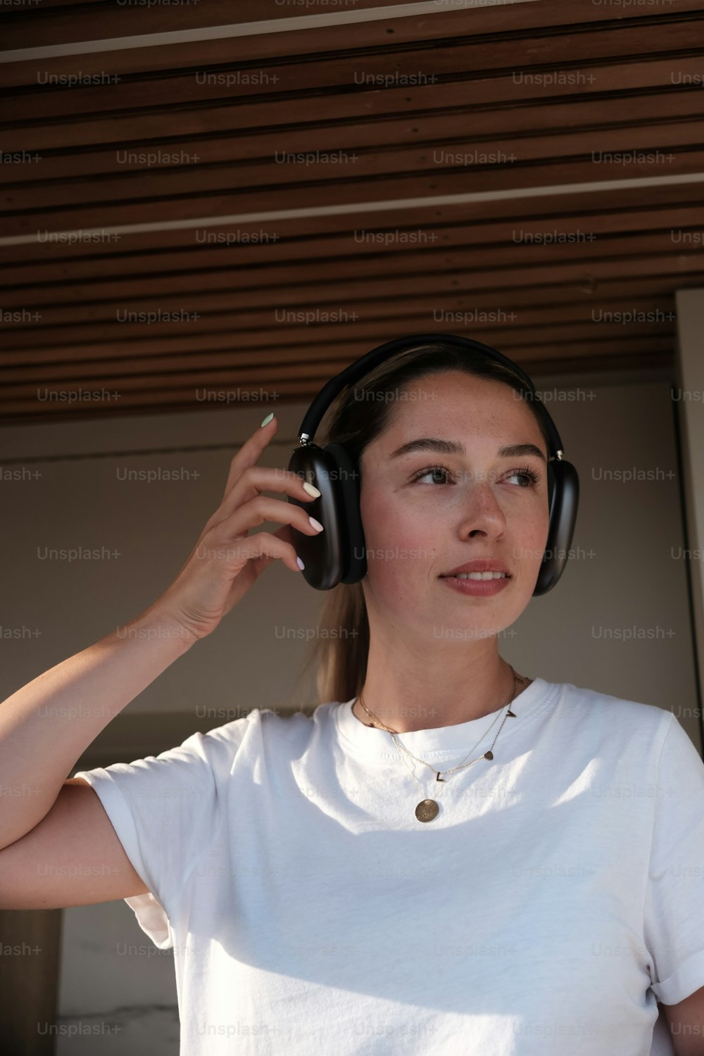 a woman wearing headphones and a white shirt