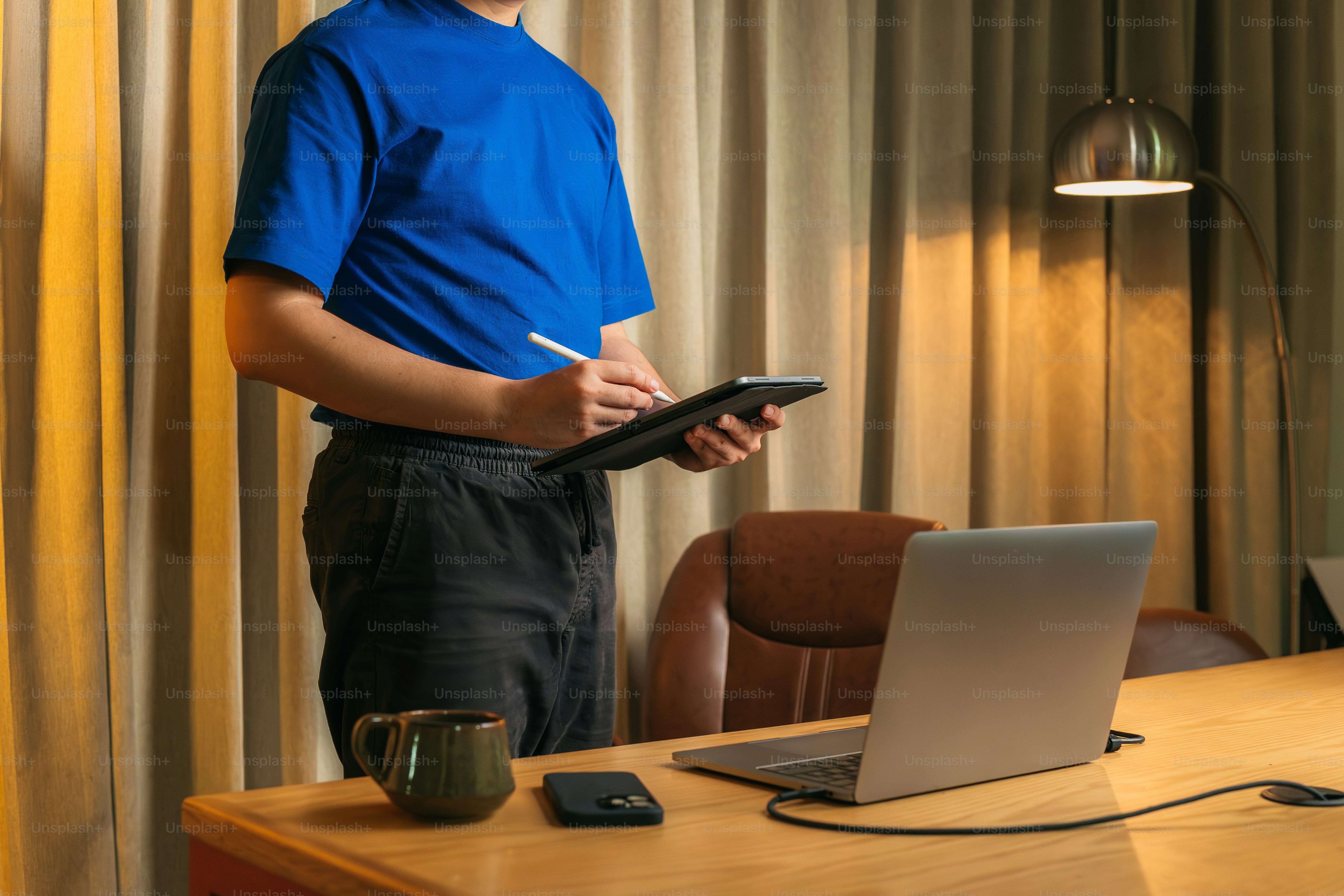 a man standing in front of a laptop computer