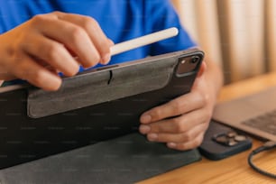 a person is holding a cigarette and a tablet