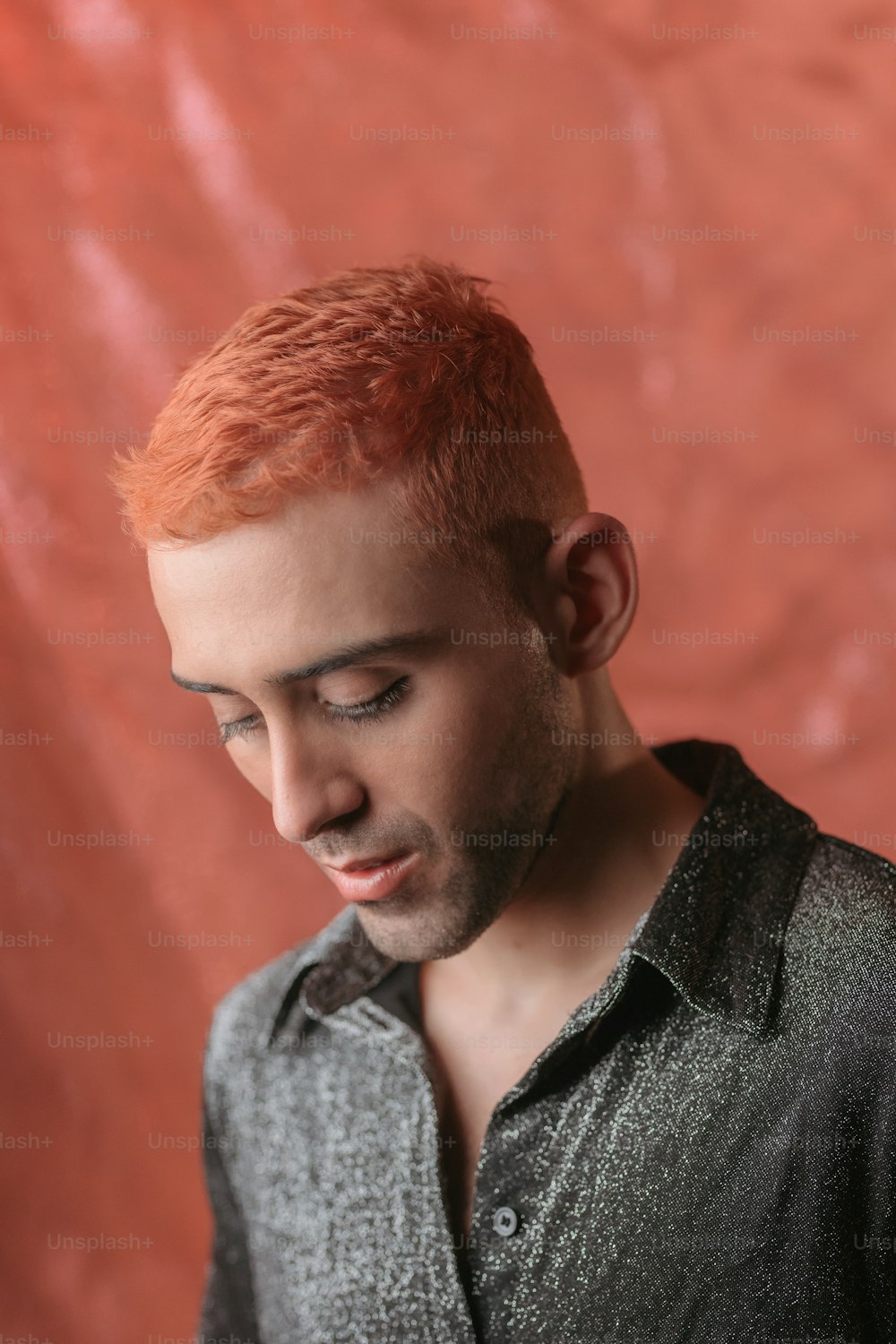 a man with red hair is looking down