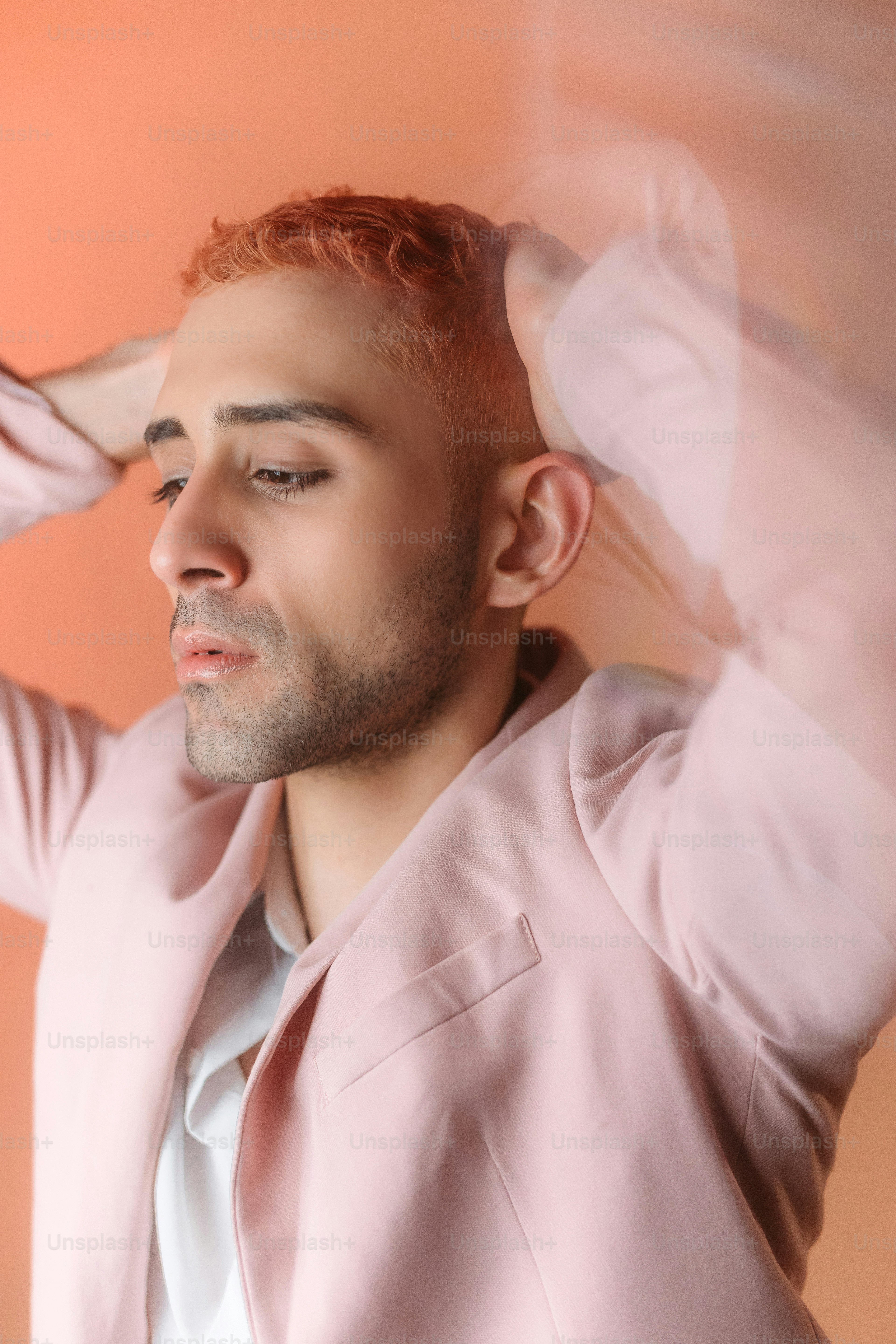 un homme aux cheveux roux vêtu d’un costume rose