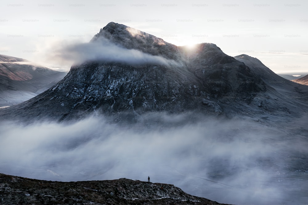 a man standing on top of a snow covered mountain