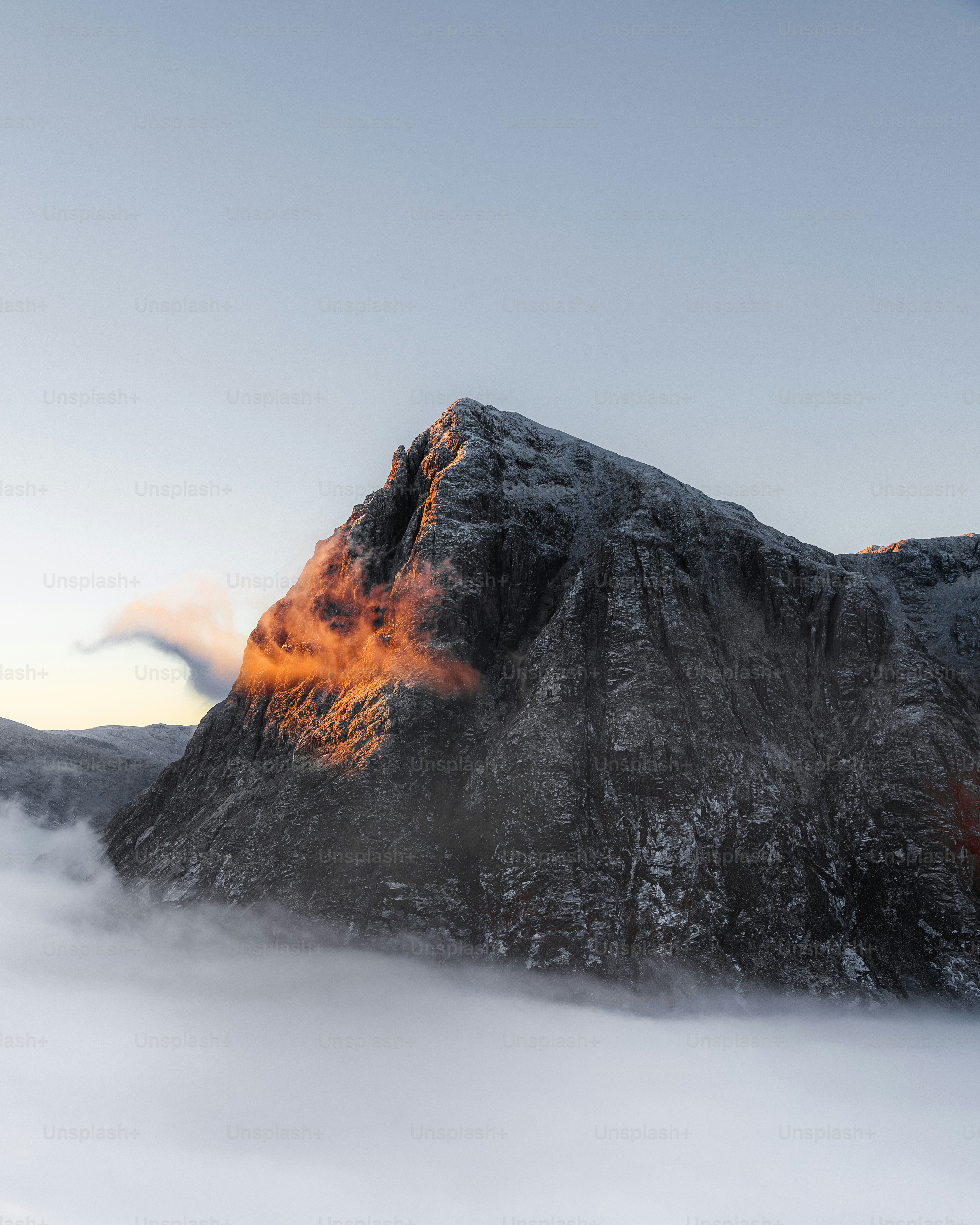 A very tall mountain covered in snow under a cloudy sky photo – Travel ...