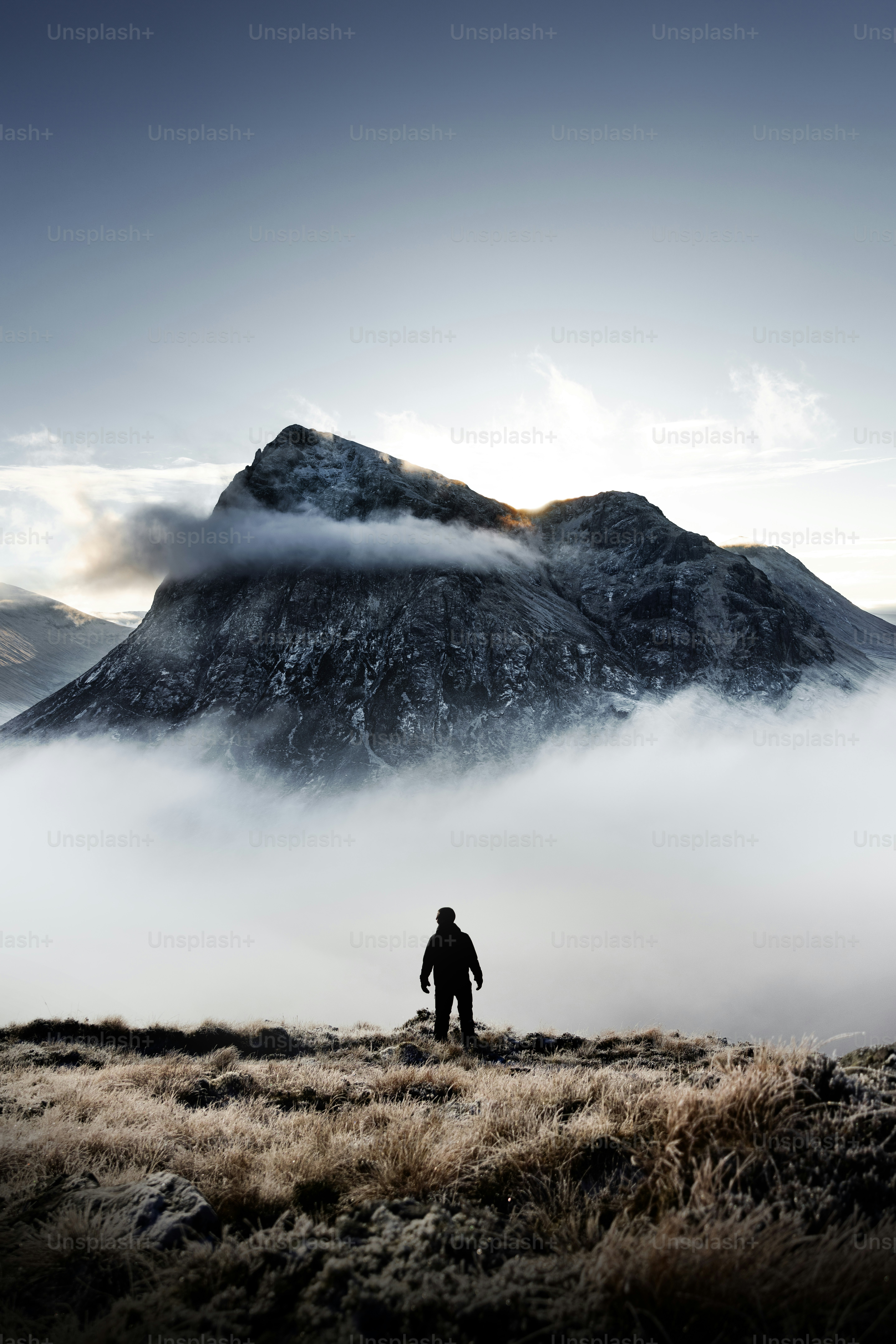 a man standing on top of a grass covered field