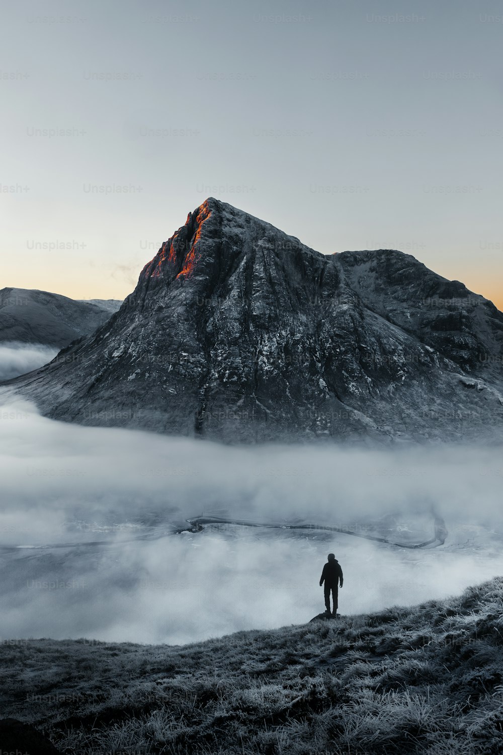 a man standing on top of a snow covered mountain