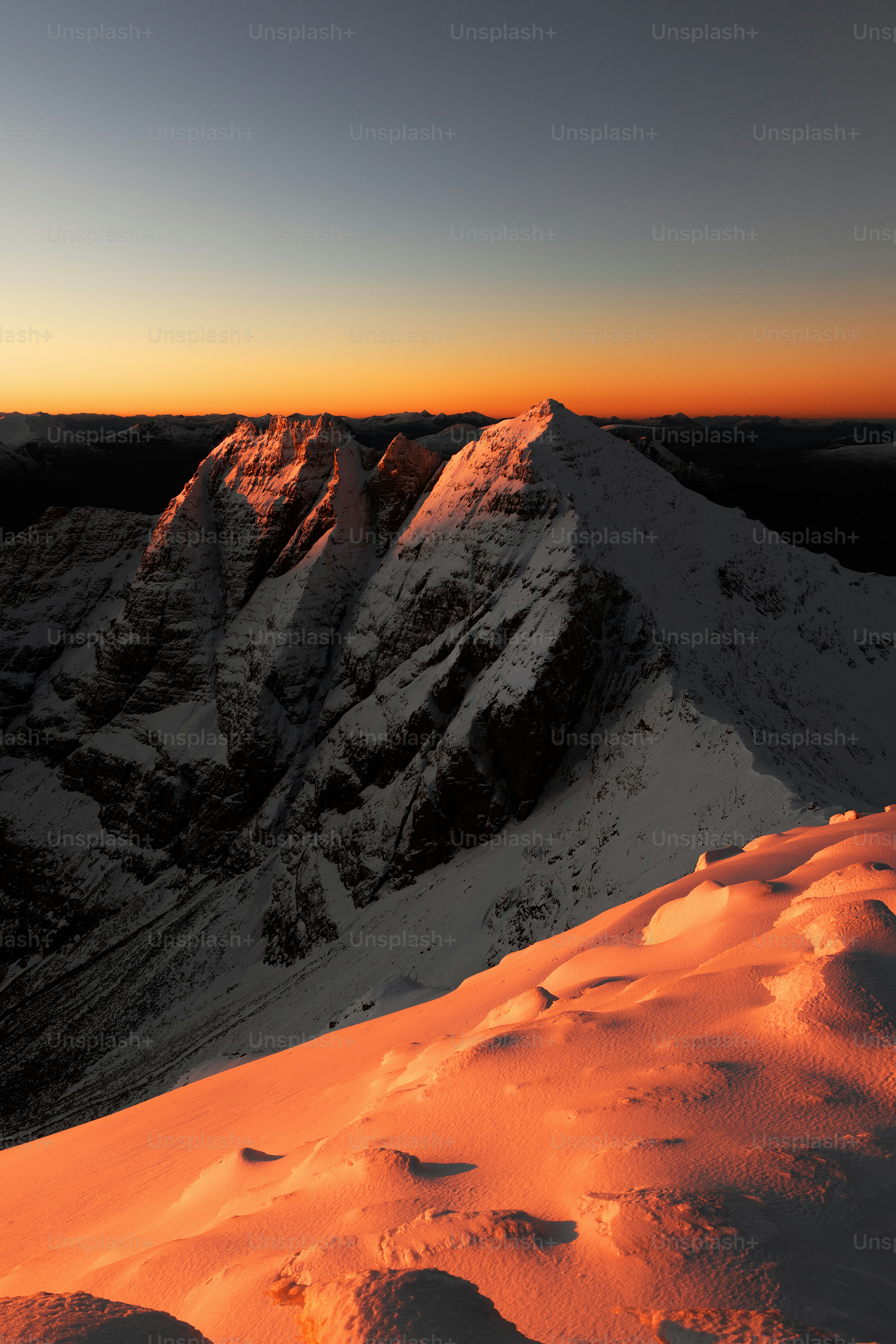 The sun is setting over a snowy mountain photo – Outdoor Image on Unsplash