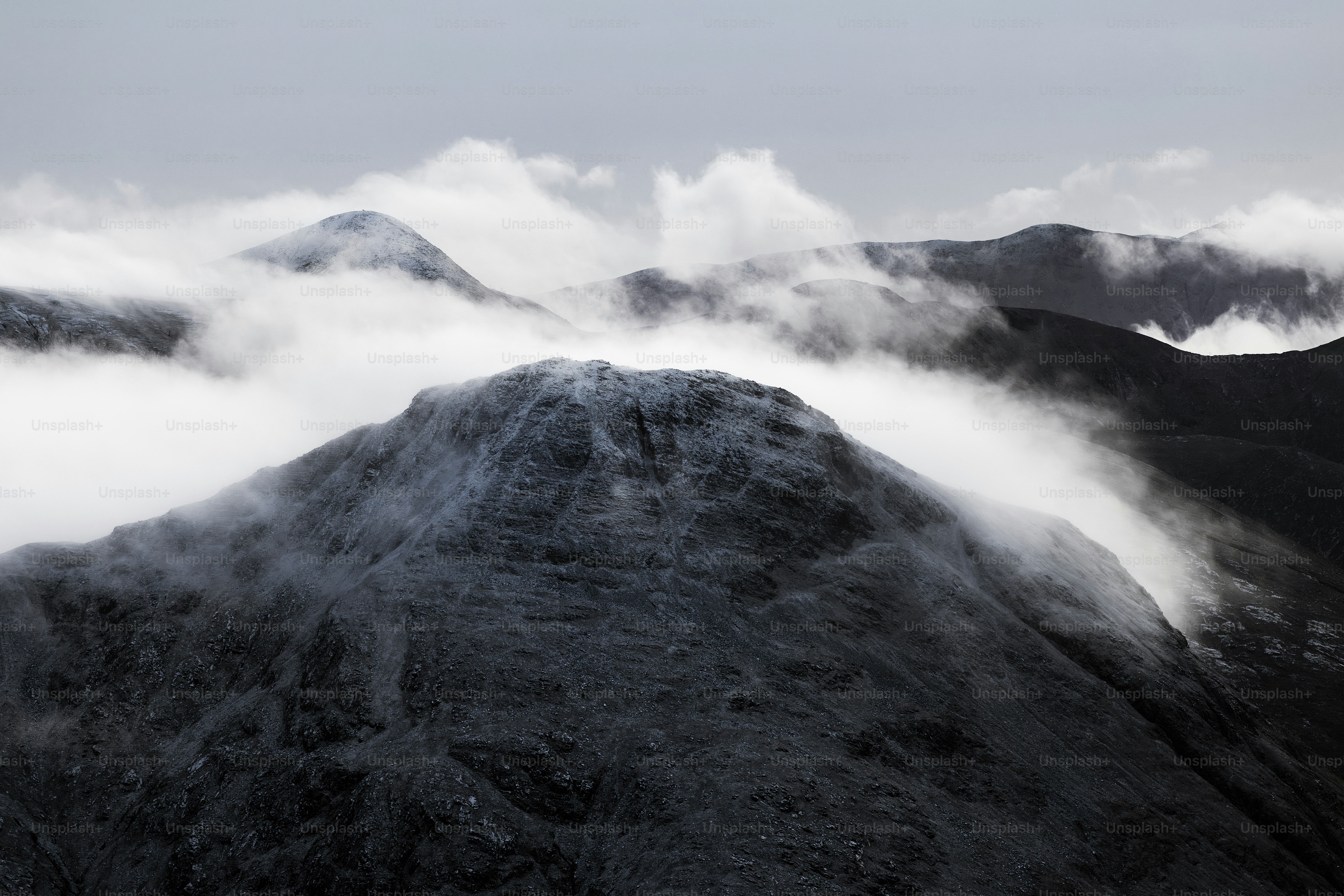 A mountain covered in fog and clouds on a cloudy day photo – Travel ...