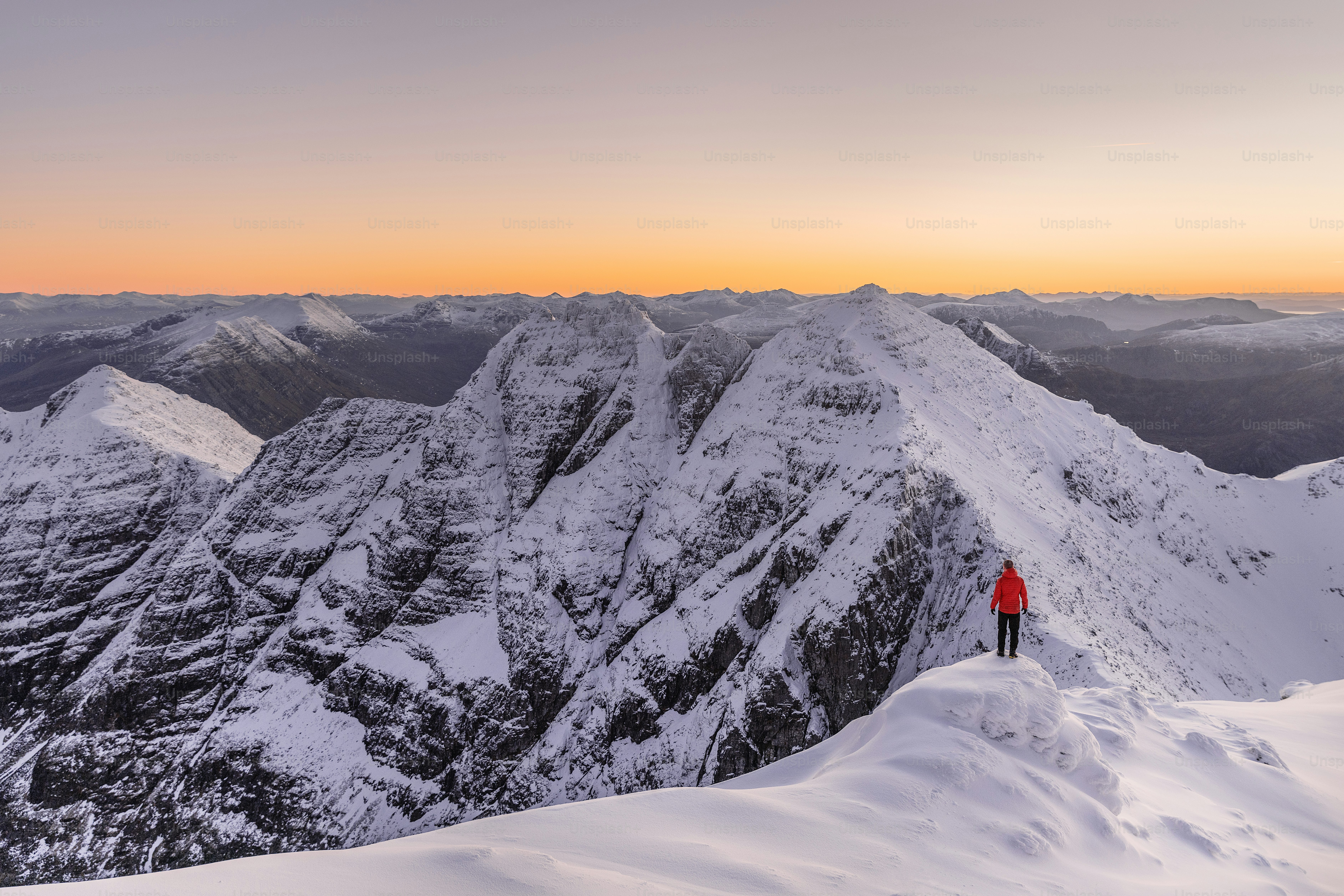 a person standing on top of a snow covered mountain