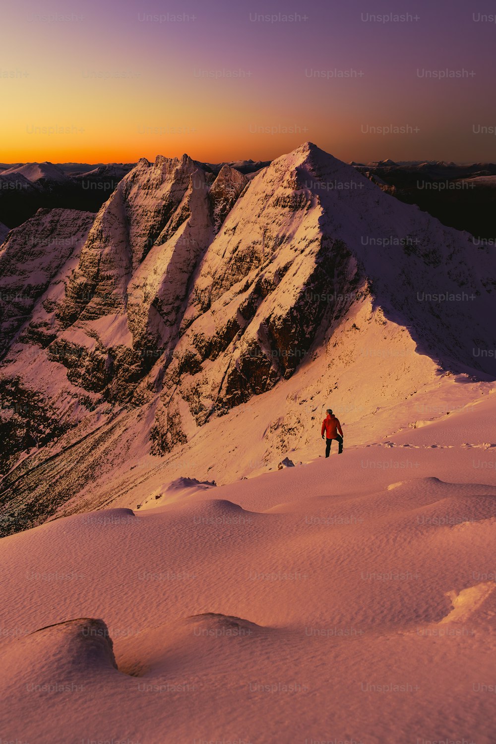 a man standing on top of a snow covered mountain