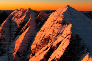 a view of the top of a mountain at sunset