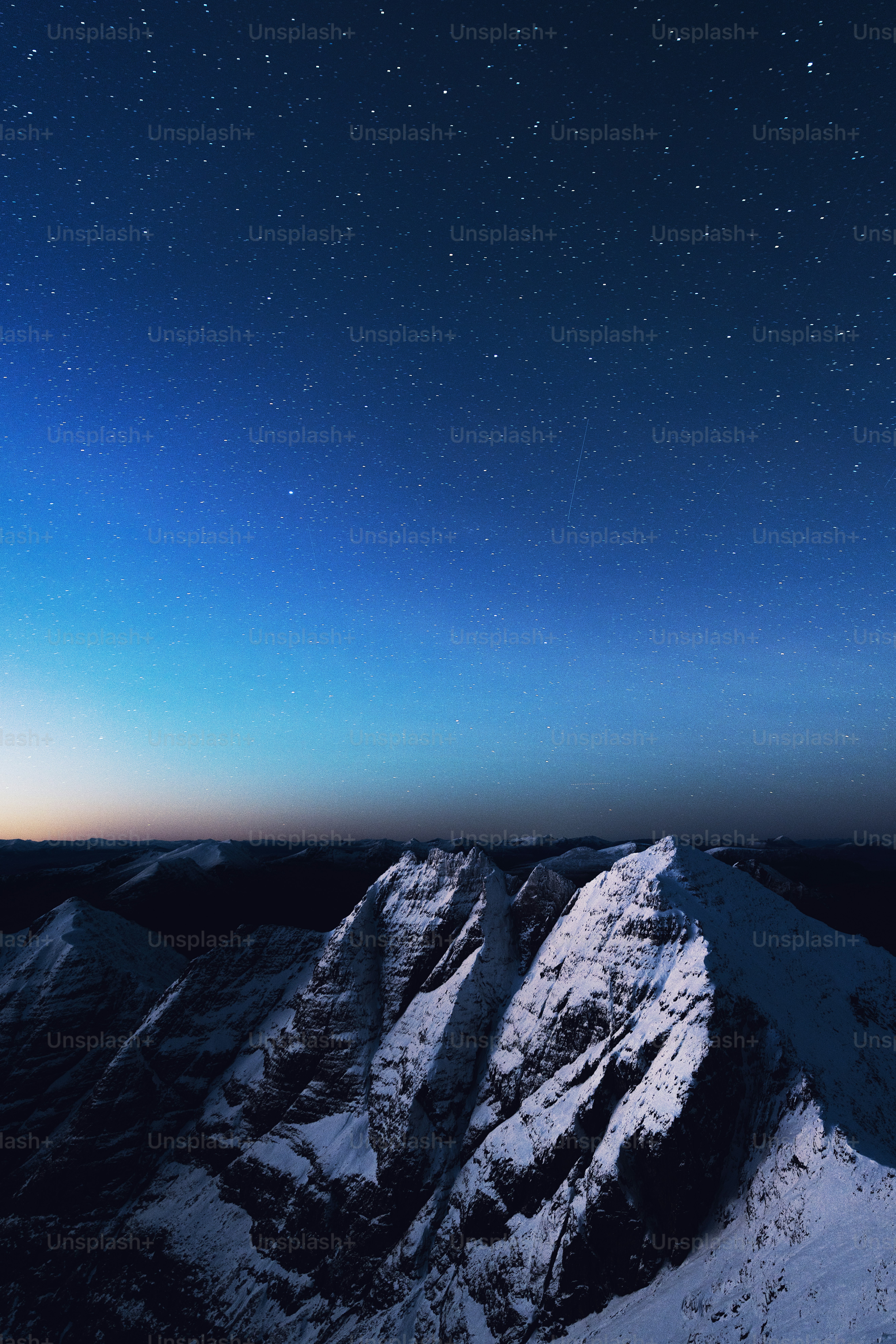 The night sky over a snowy mountain range photo – An teallach Image on ...
