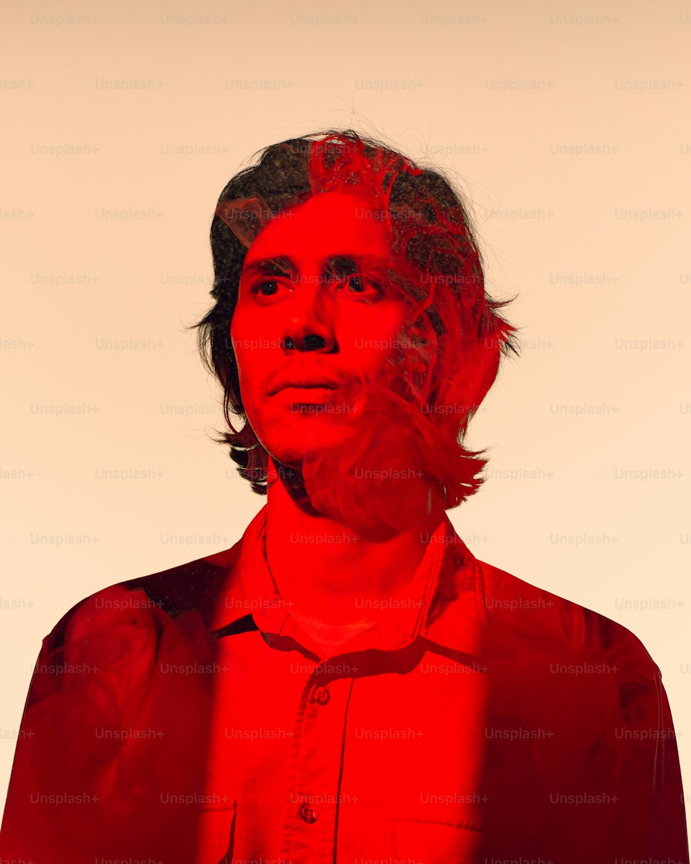 a person with a red shirt and a red background
