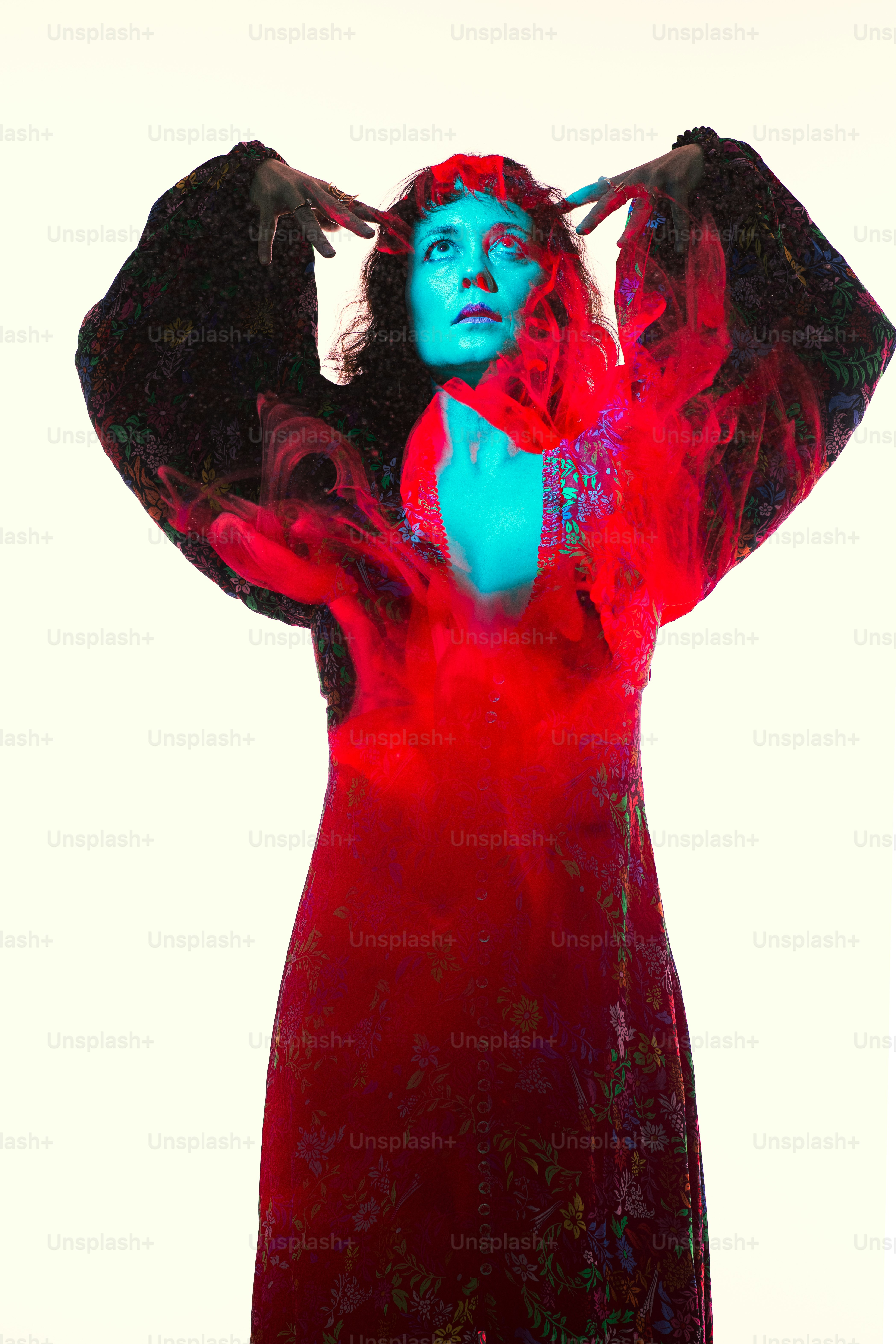 a woman in a red dress with a bird on her shoulder