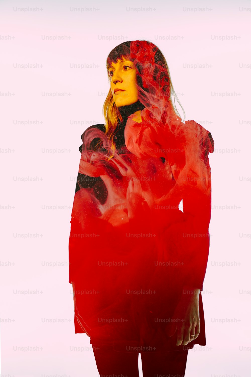 a woman in a red dress with a red background