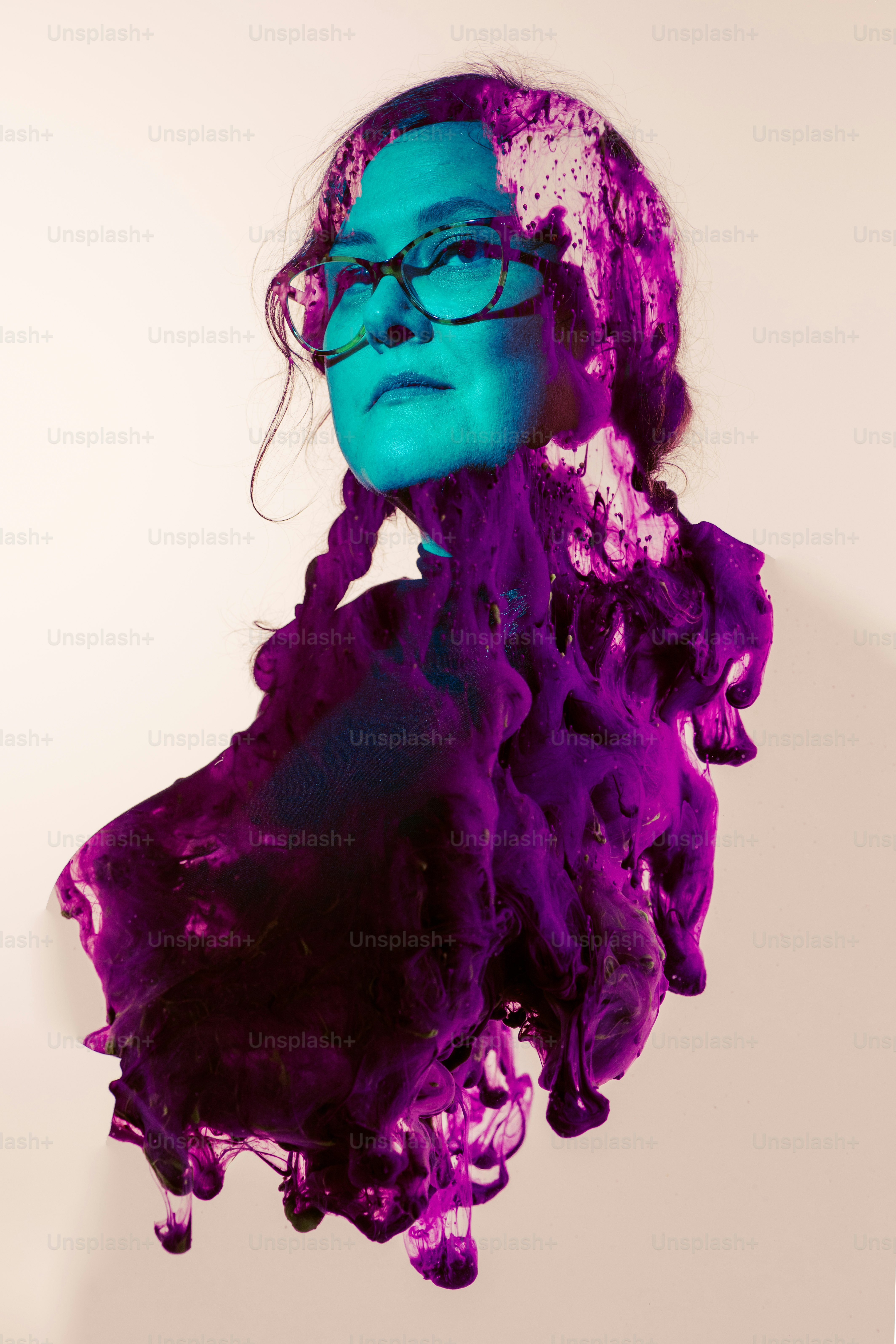 a woman's face covered in purple ink