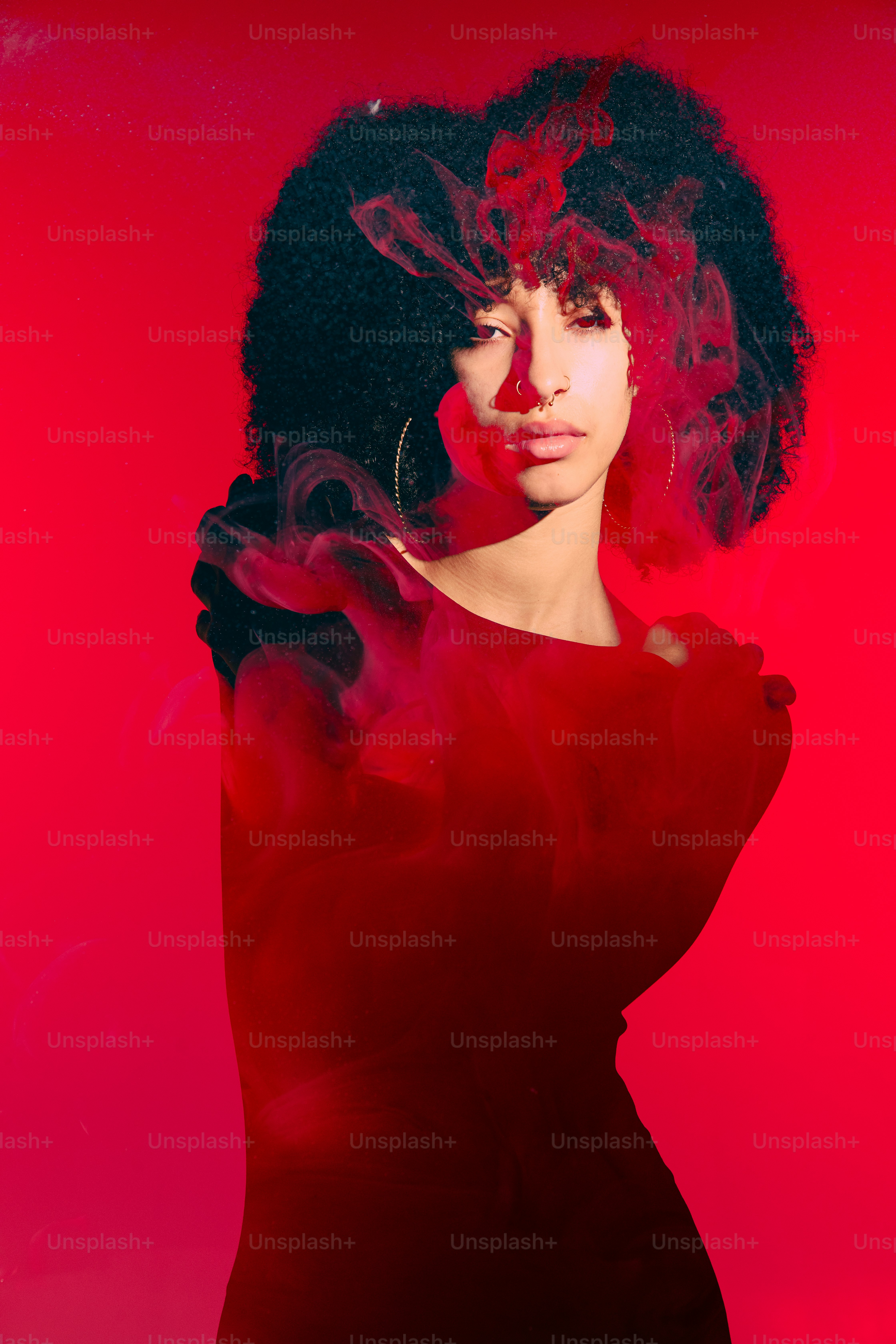 A woman in a red dress with a red background photo – Conceptual Image ...