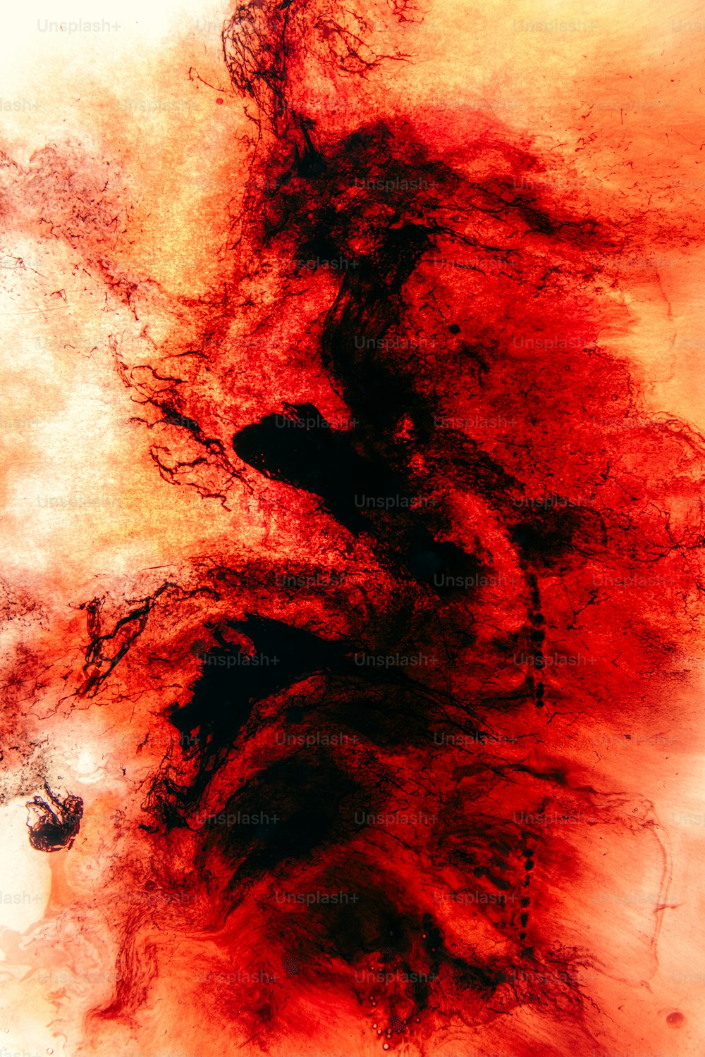 a painting of red and black paint on a white background
