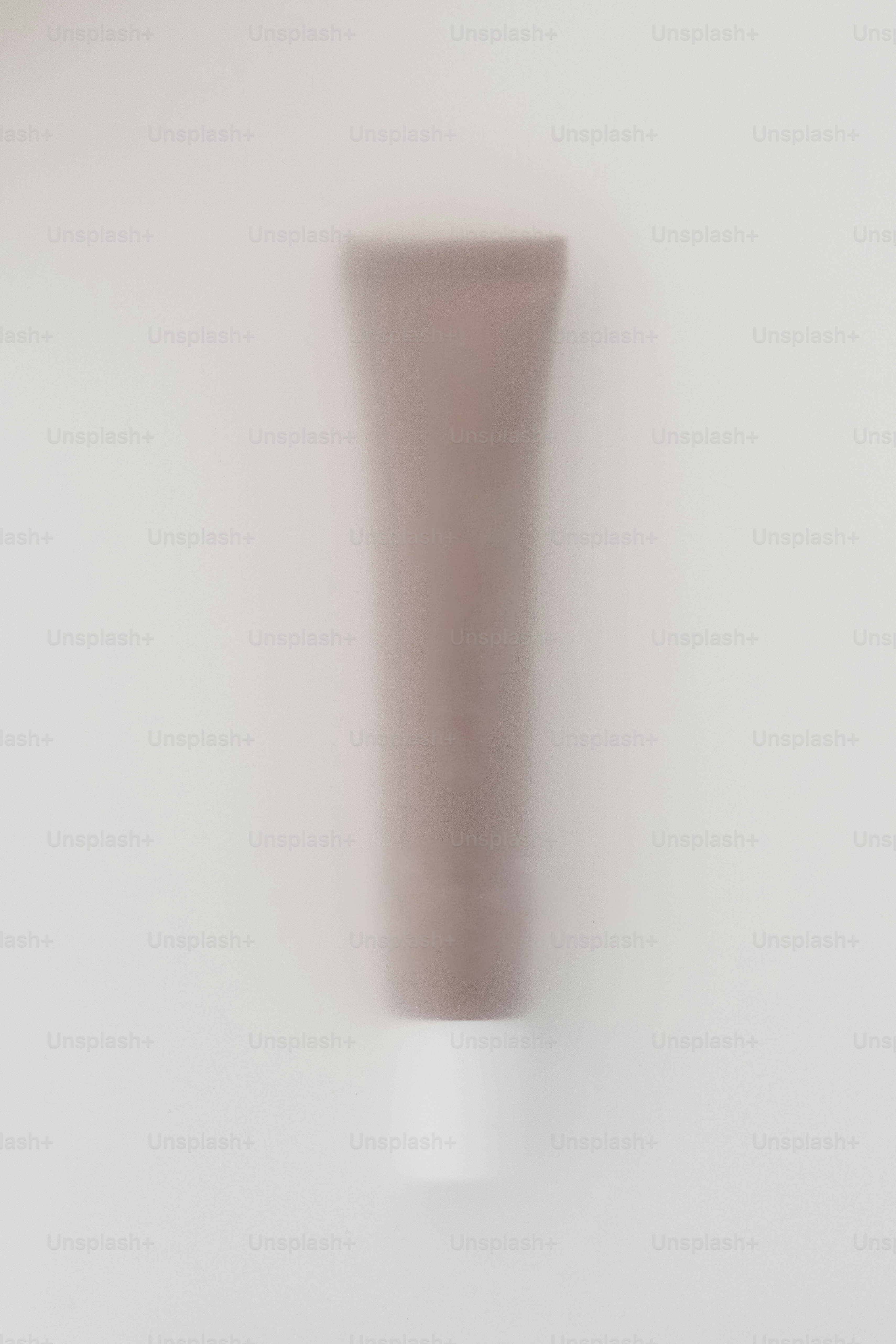 a white vase sitting on top of a white wall