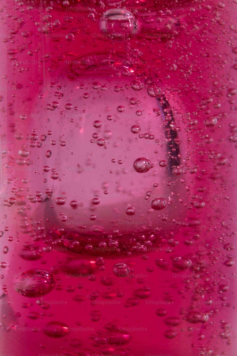 a close up of a bottle of water with drops of water on it