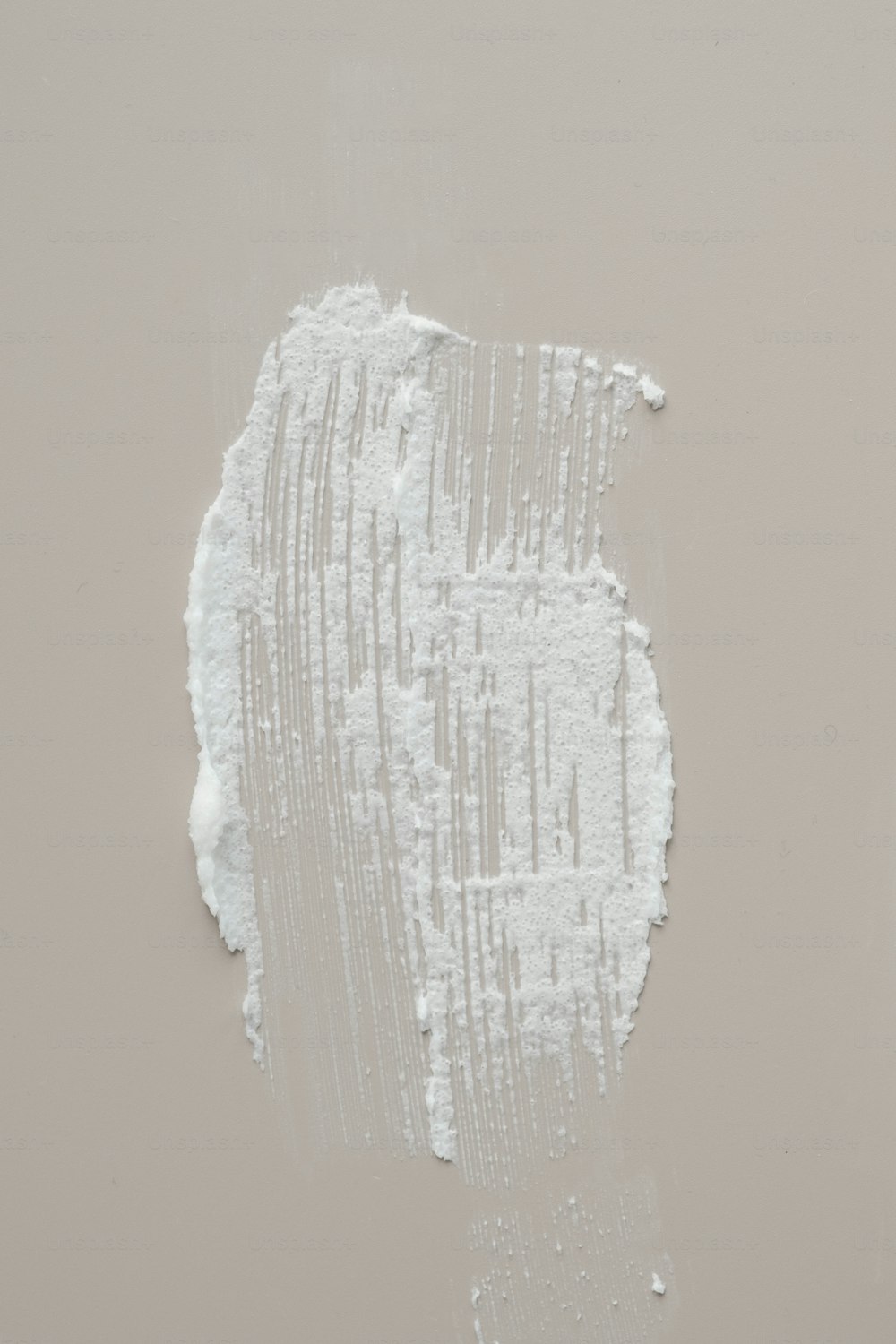 a piece of white paint that is peeling off of a wall
