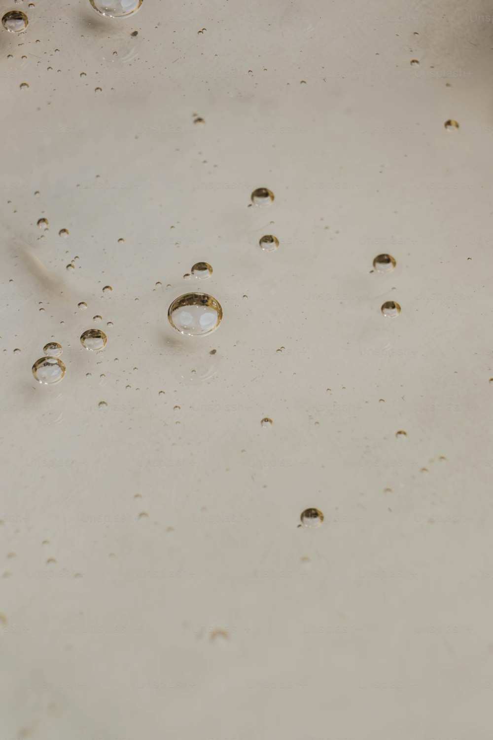a bunch of water drops on a white surface