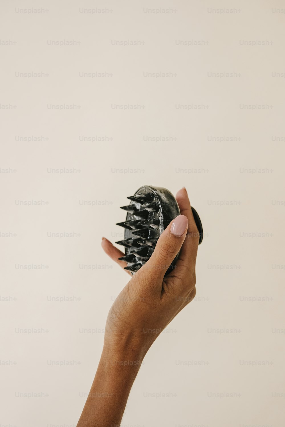 a person holding a hair brush in their hand